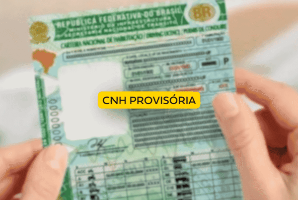 Pessoa segurando uma carteira nacional de habilitação brasileira em tom esverdeado, representando uma CNH provisória. No centro da imagem há um selo amarelo com a inscrição “CNH provisória”, destacando o documento temporário para novos condutores.