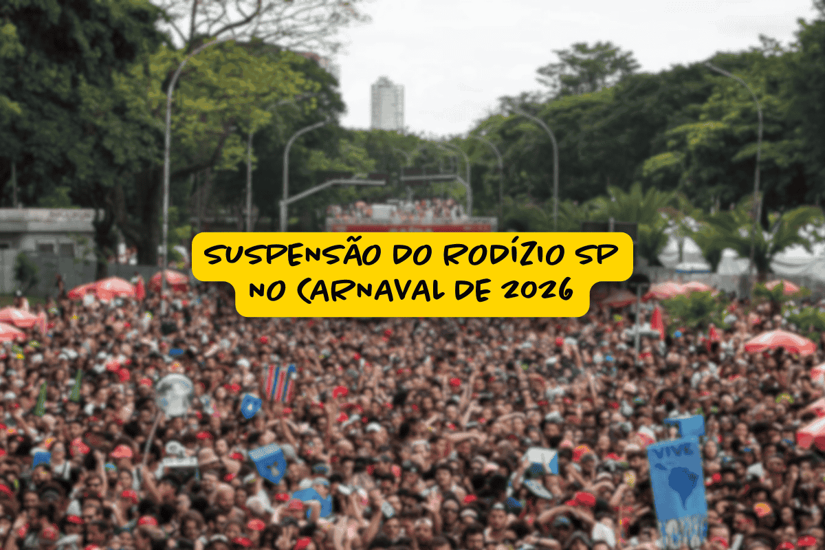 Multidão de foliões ocupa uma avenida arborizada durante o carnaval em São Paulo, com diversos adereços e sombrinhas vermelhas, enquanto um letreiro central em destaque avisa: “Suspensão do rodízio SP no Carnaval de 2026”.